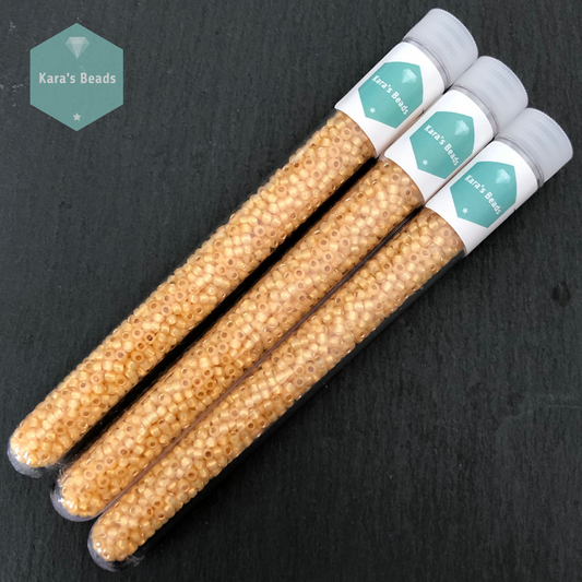 25g Tube 8/0 Toho TR8-2110 Silver Lined Milky Light Topaz