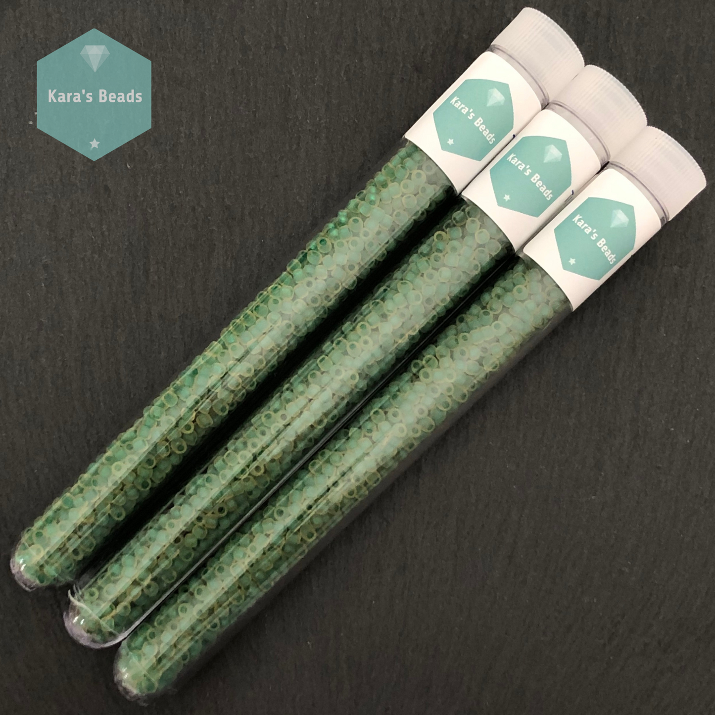 25g Tube 8/0 Toho TR8-242FM Emerald Lined Frosted Topaz